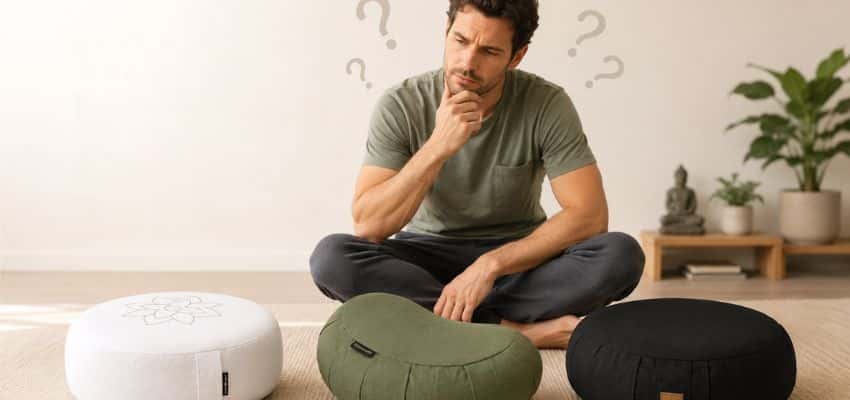 A thoughtful man comparing different cushions while wondering what meditation cushion height he needs for comfortable floor sitting.
